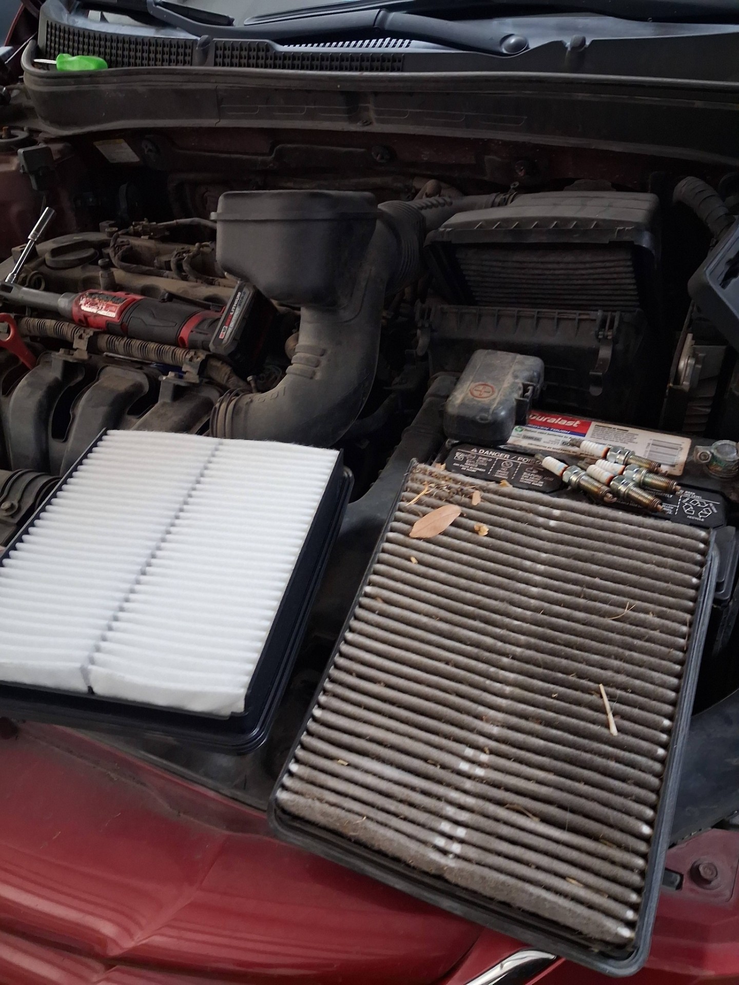 Side by side comparison of an old and new engine air filter